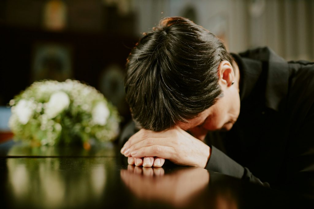 Woman Crying on Coffin