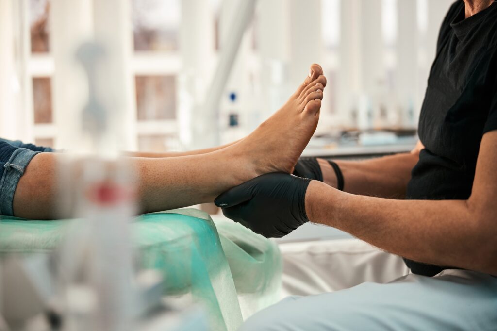 Close up of competent doctor doing foot massage