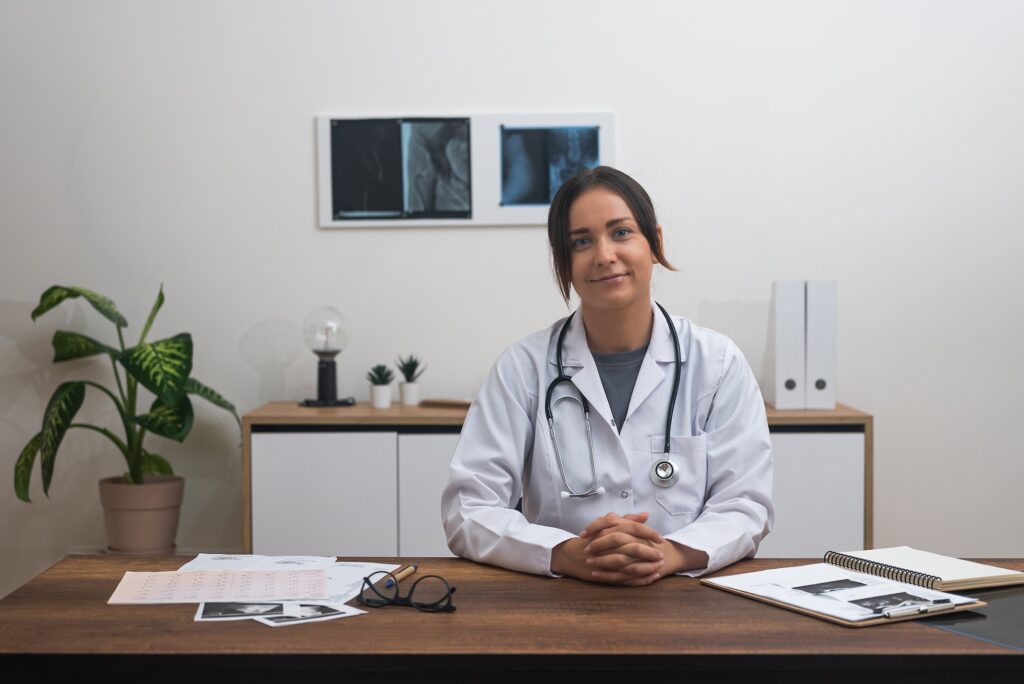female doctor, makes eye contact with the camera in an online medical consultation.