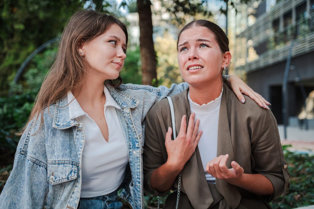 Upset woman sharing her problems with a comforting friend in an emotional , depicting support