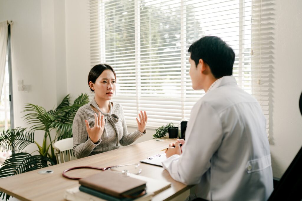 Doctor talking to patient and filling patient history, examination, treatment, medical