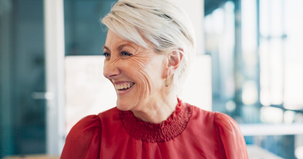 Face, laugh or humor and a senior business woman at work in her office with a carefree or positive