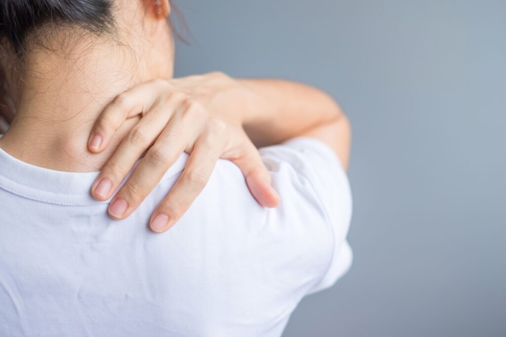woman with her shoulder sprain. Shoulder ache, Scapular pain, office syndrome and ergonomic concept