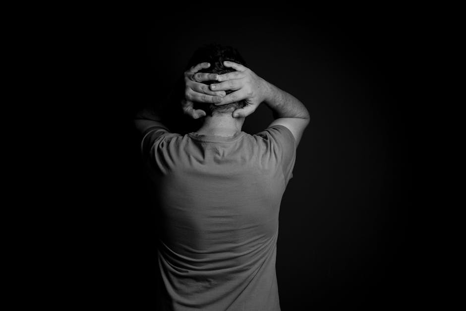 Anxious person sitting alone in a dark room