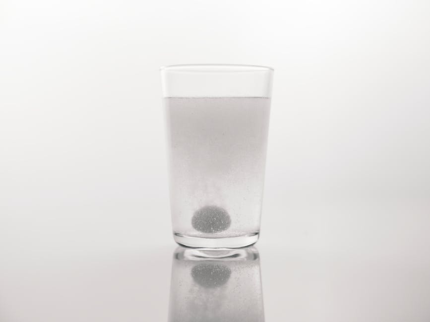 Glass of water with chlorine tablets or filtration concept