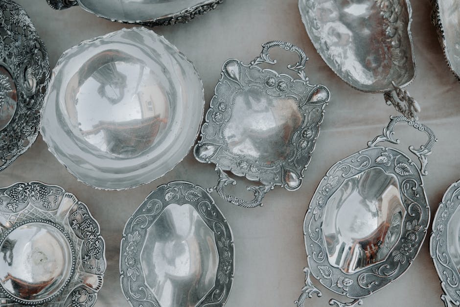 Old metal tableware and lead pewter plates on a wooden table