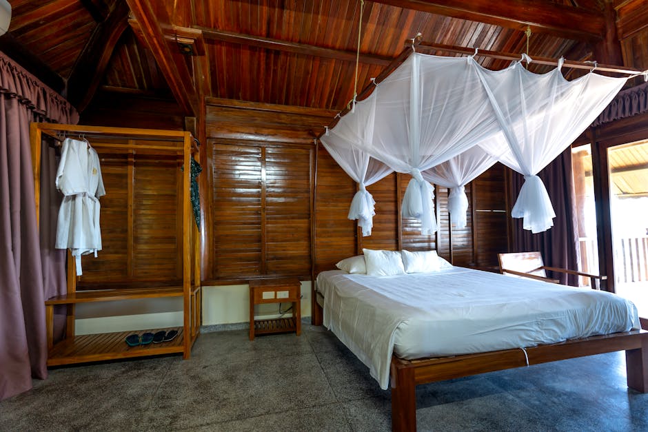 Person sleeping peacefully in a clean bedroom with closed windows and mosquito net