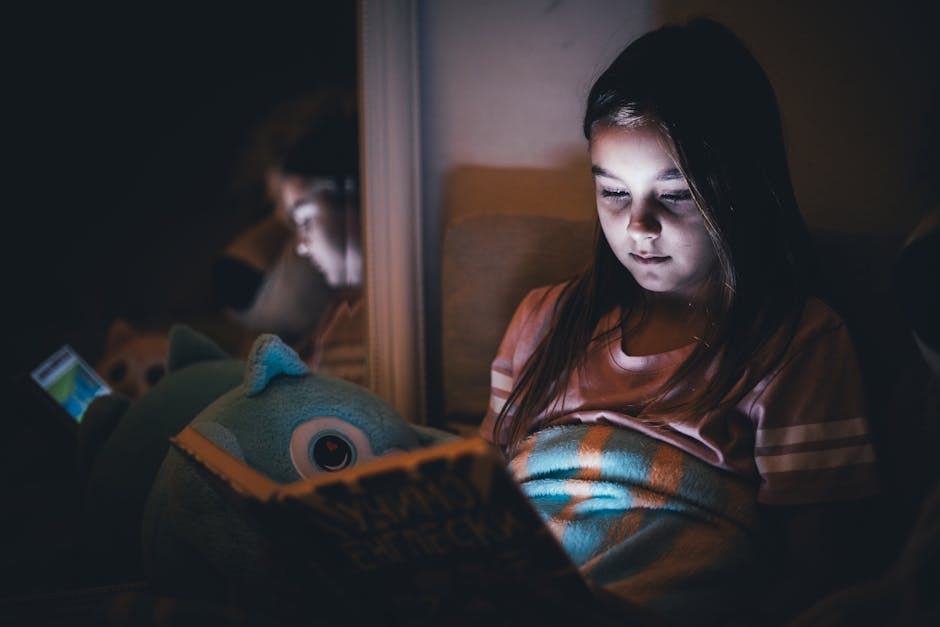 Child and teenager using tablets at home in the evening