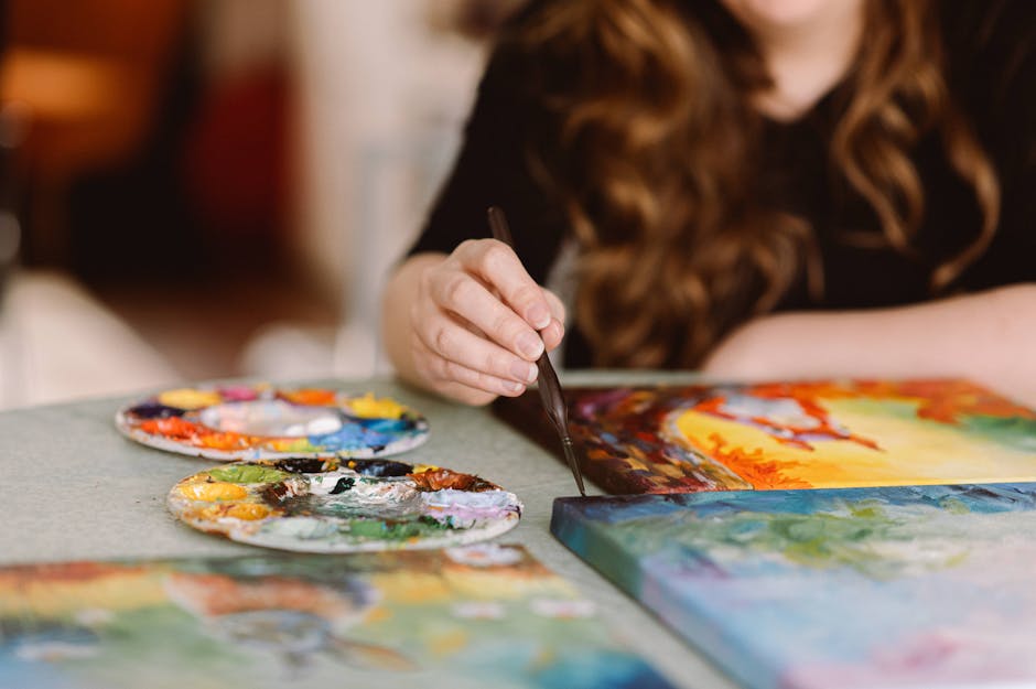 Artist painting with vivid colors inspired by music and sound