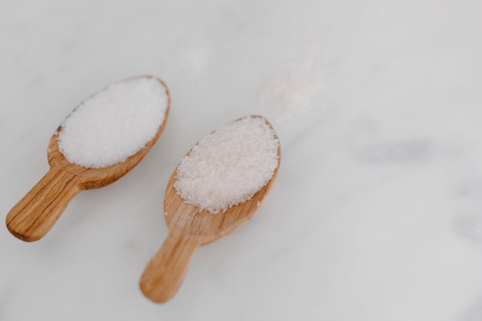 Table salt and sodium concept with measuring spoon