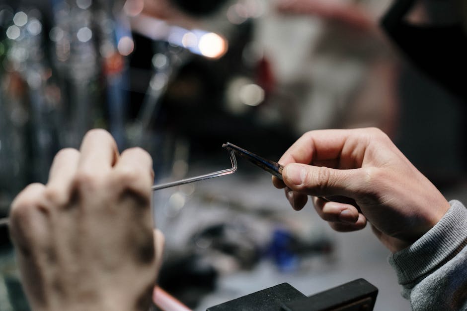 Molten glass being shaped in a hot workshop