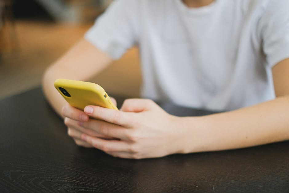 Person reading a daily horoscope on a smartphone with a thoughtful expression