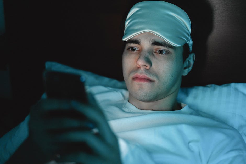 Adolescent using a smartphone in bed at night