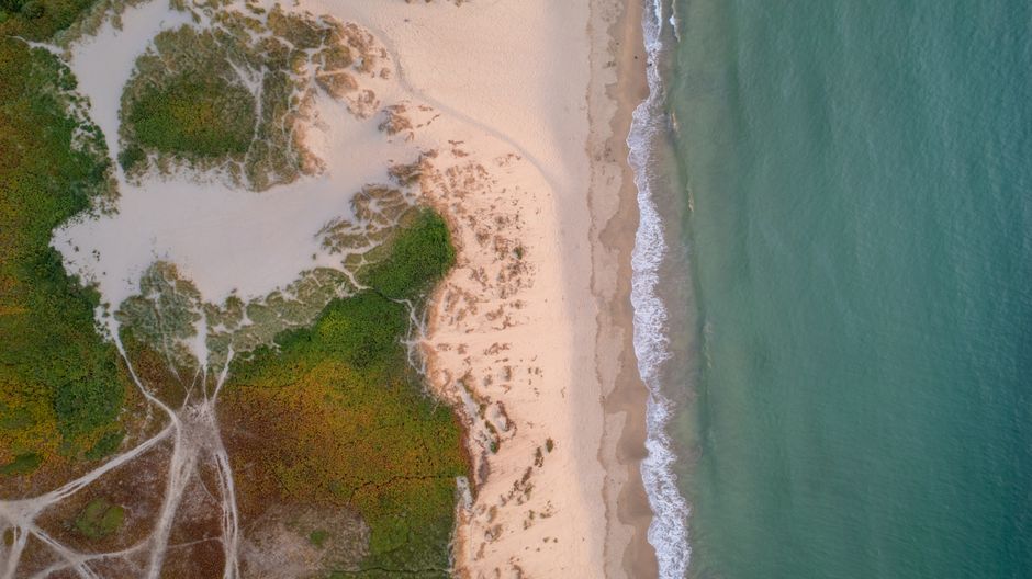 Aerial view of coastline erosion and sand extraction