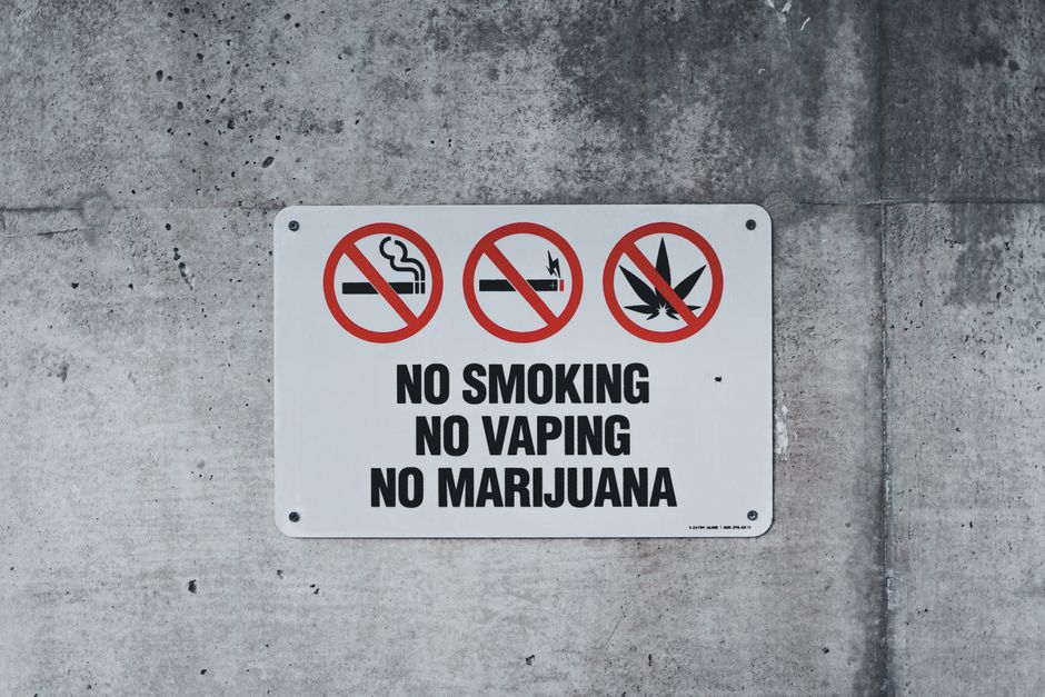 Gas station warning sign with no smoking and no mobile phone icons