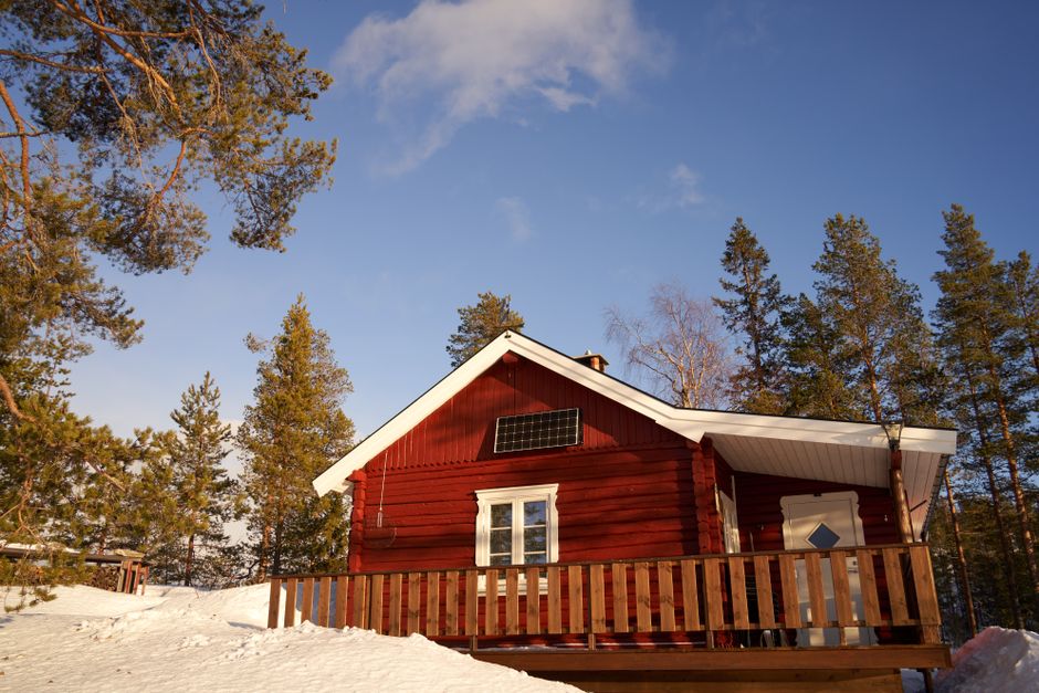 Snow-covered solar panels on a roof in winter