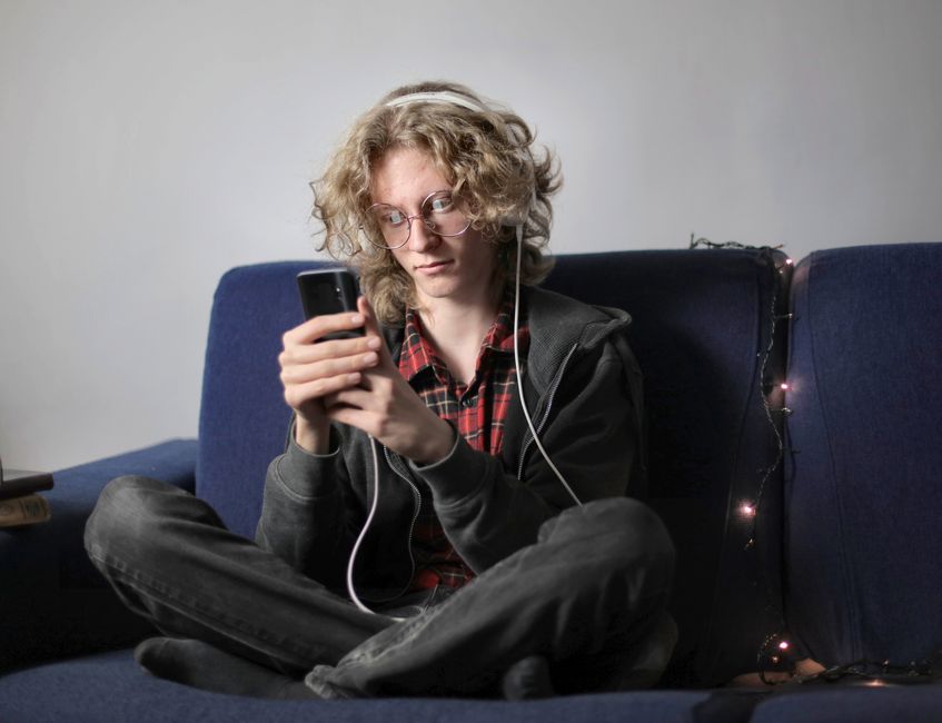 Teenager using headphones with smartphone in a safe and relaxed way