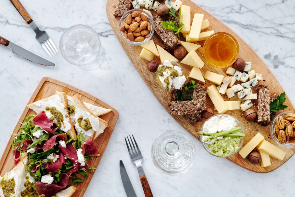 Assorted cheeses on a wooden board with blue cheese and aged cheese