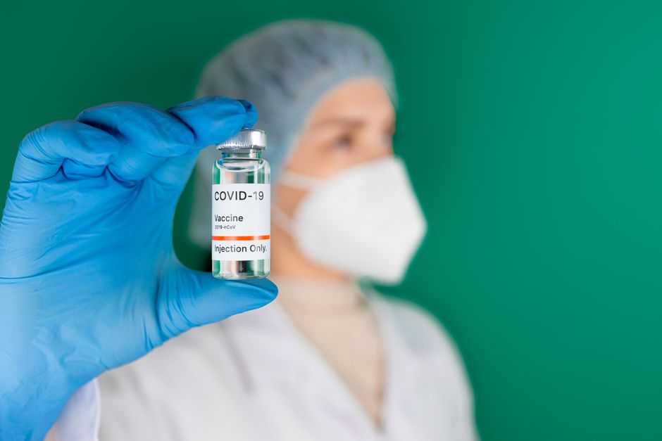 Scientist examining vaccine vial in laboratory