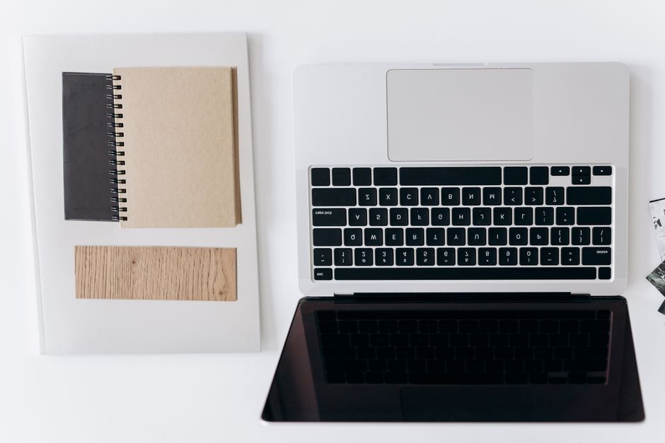 Writer staring at a blank page on a laptop in a quiet workspace