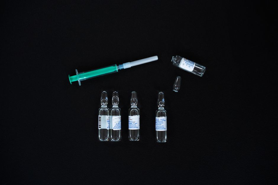 Medical vial and syringe on clean background