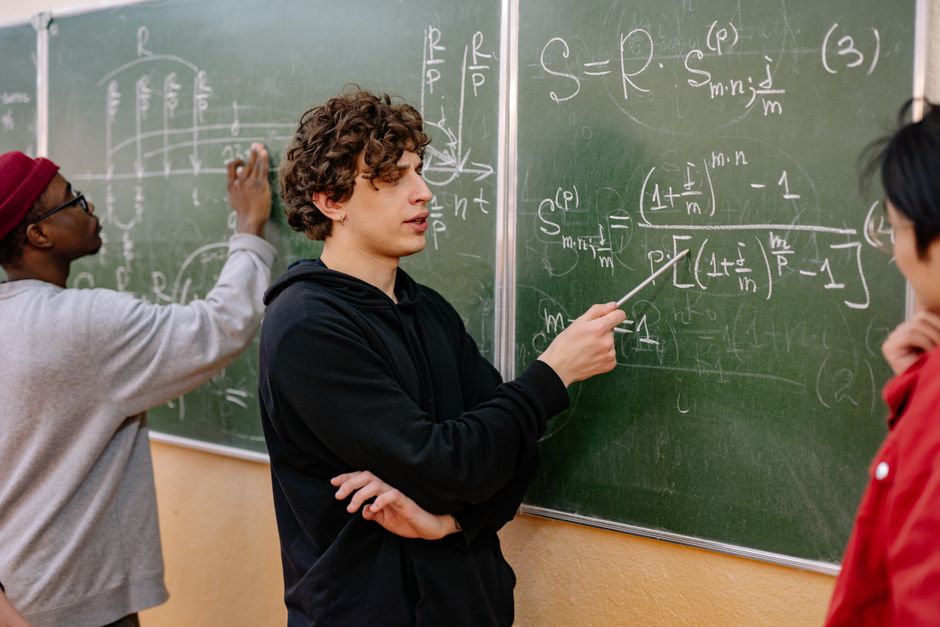 Students studying mathematics in classroom