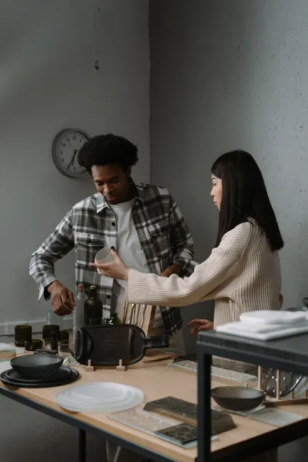 Teamwork in a stylish kitchen setting with two professionals preparing a meal.
