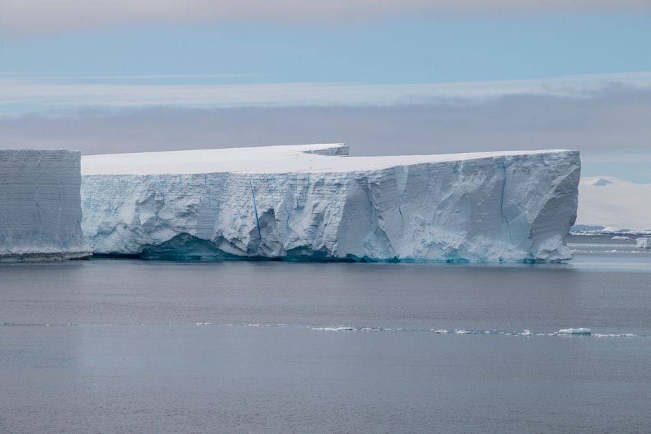 Stunning view of a massive iceberg floating in the serene Antarctic waters.