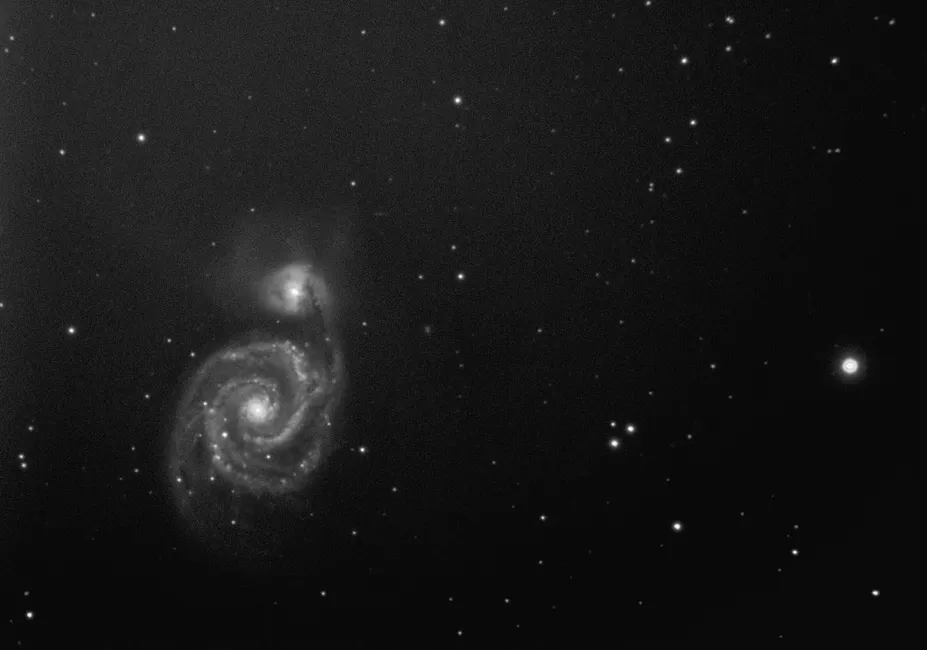 A captivating black and white image of a spiral galaxy in the expansive cosmos.