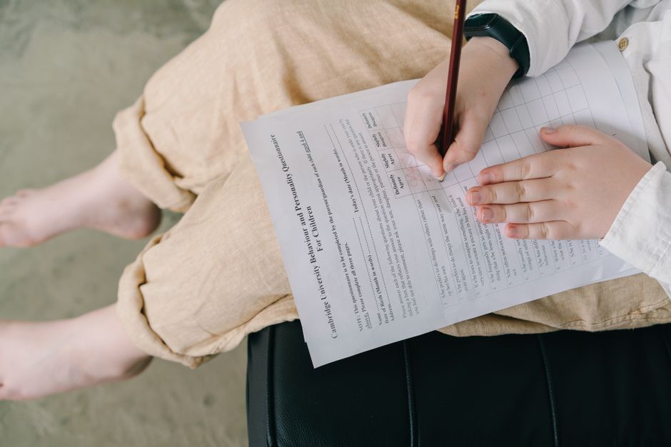 Young child completing a questionnaire indoors for educational purposes.